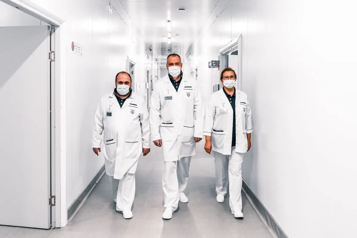 Medical professionals walking together through a hospital corridor