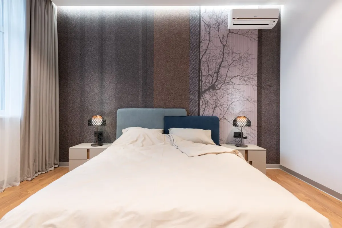 Modern bedroom with a double bed, bedside lighting and curtains