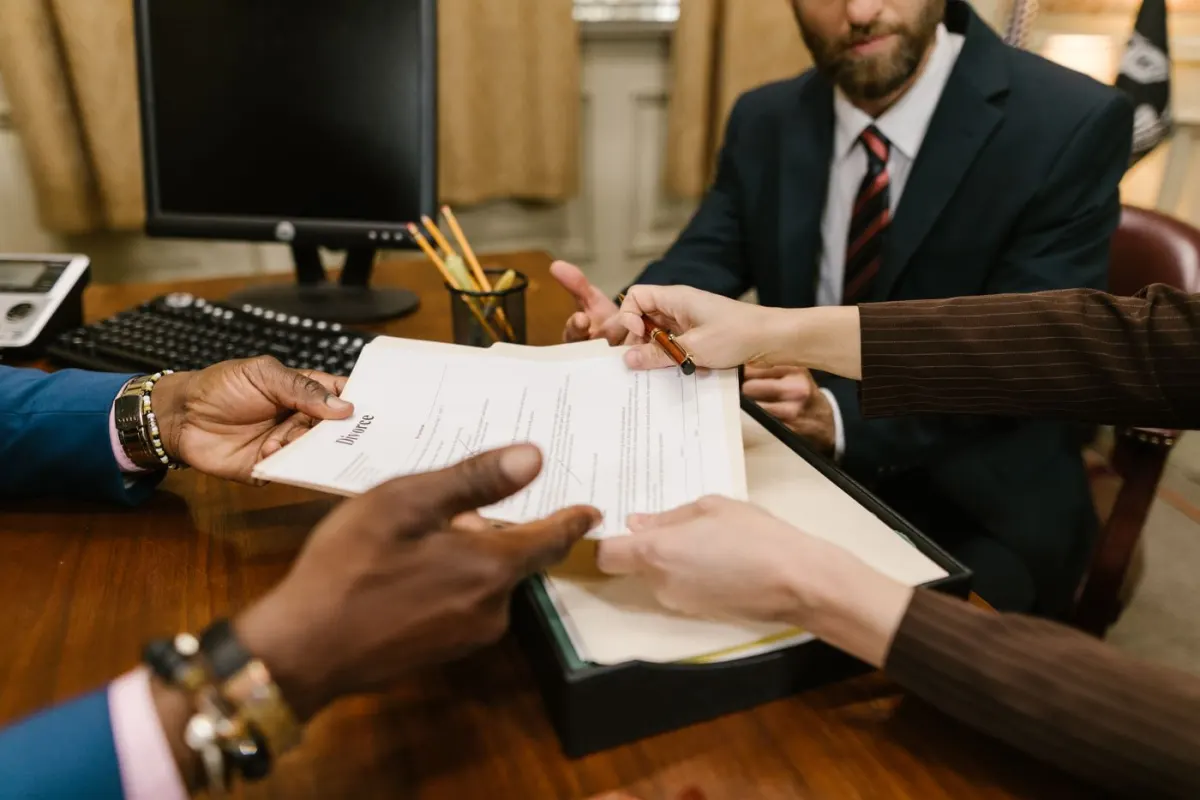 People reviewing paperwork together during an office meeting