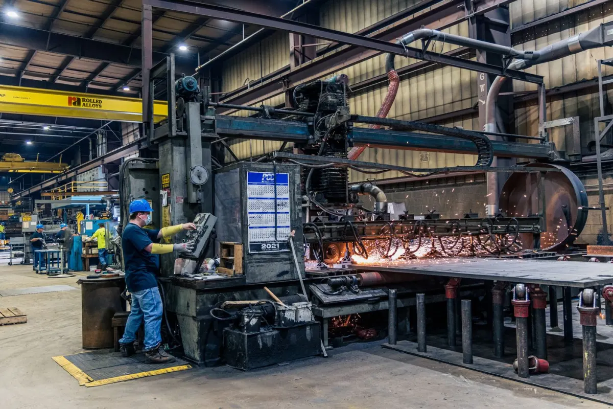 Worker operating industrial machinery on a manufacturing floor