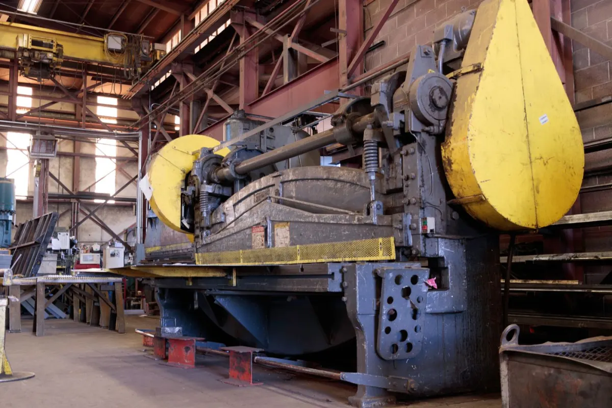 Heavy industrial machinery inside a factory production area