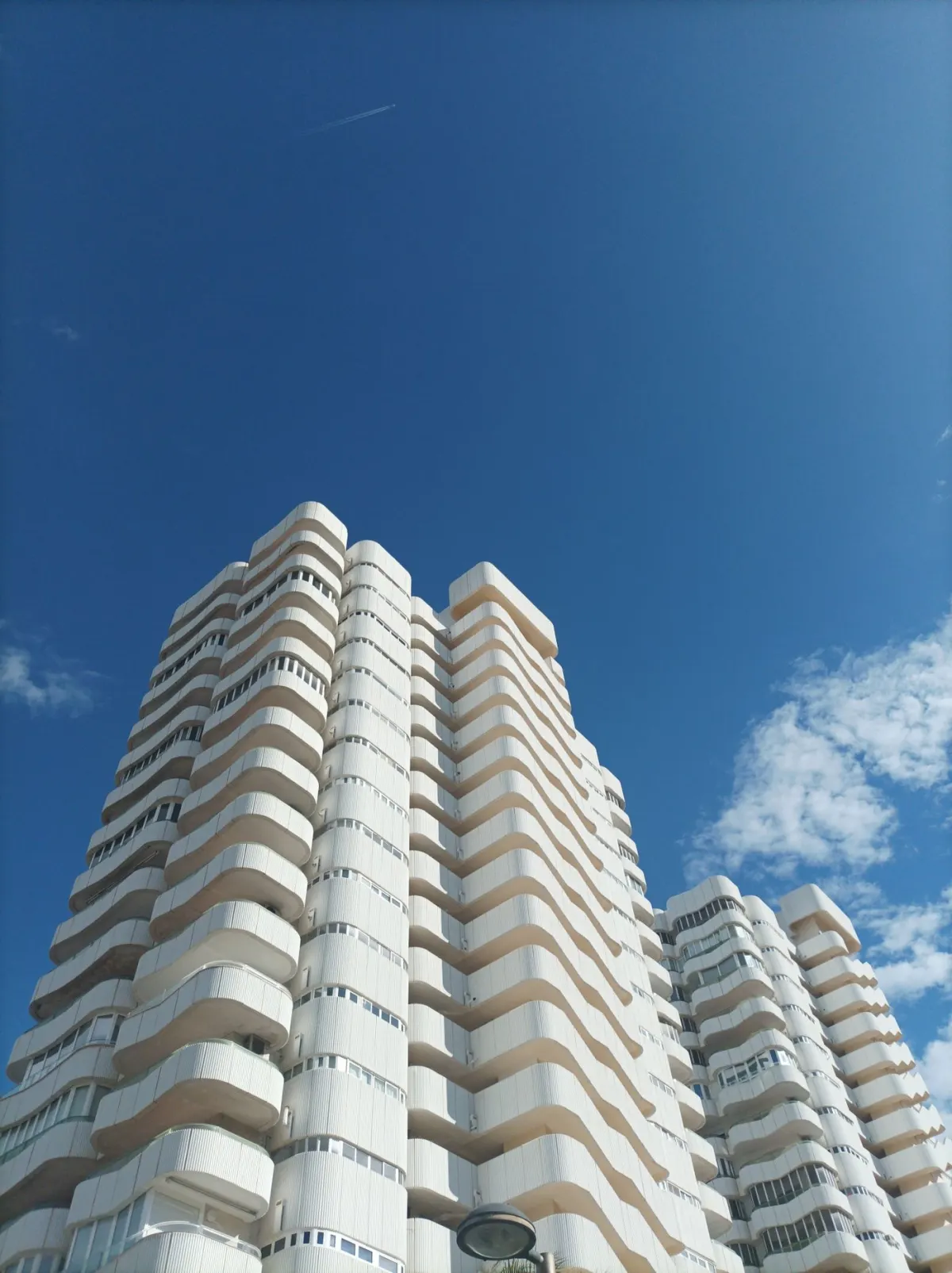 Modern residential towers rising against a blue sky
