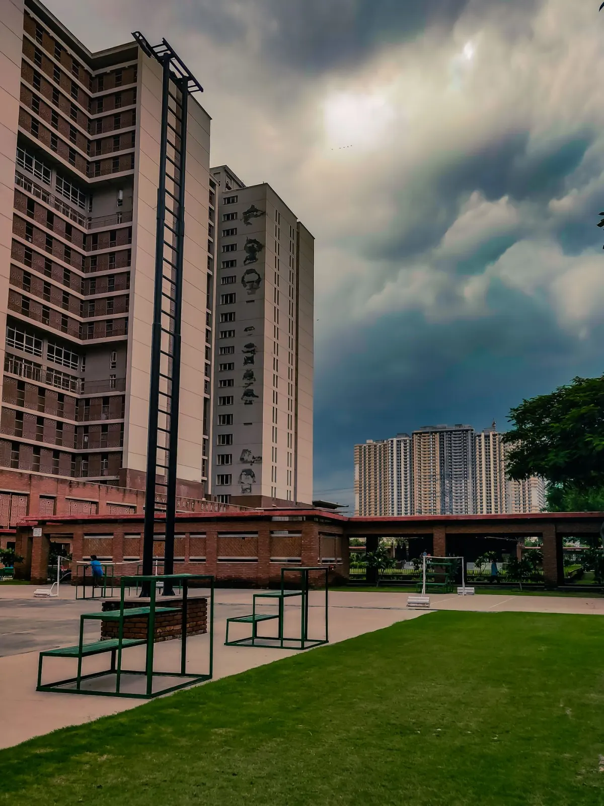 Contemporary apartment buildings and landscaped grounds beneath a cloudy sky