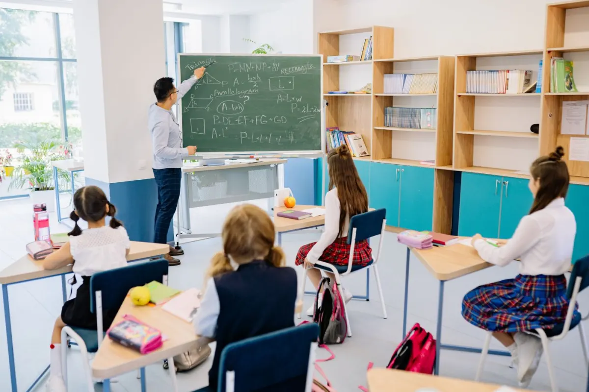 Teacher working with students during a classroom lesson
